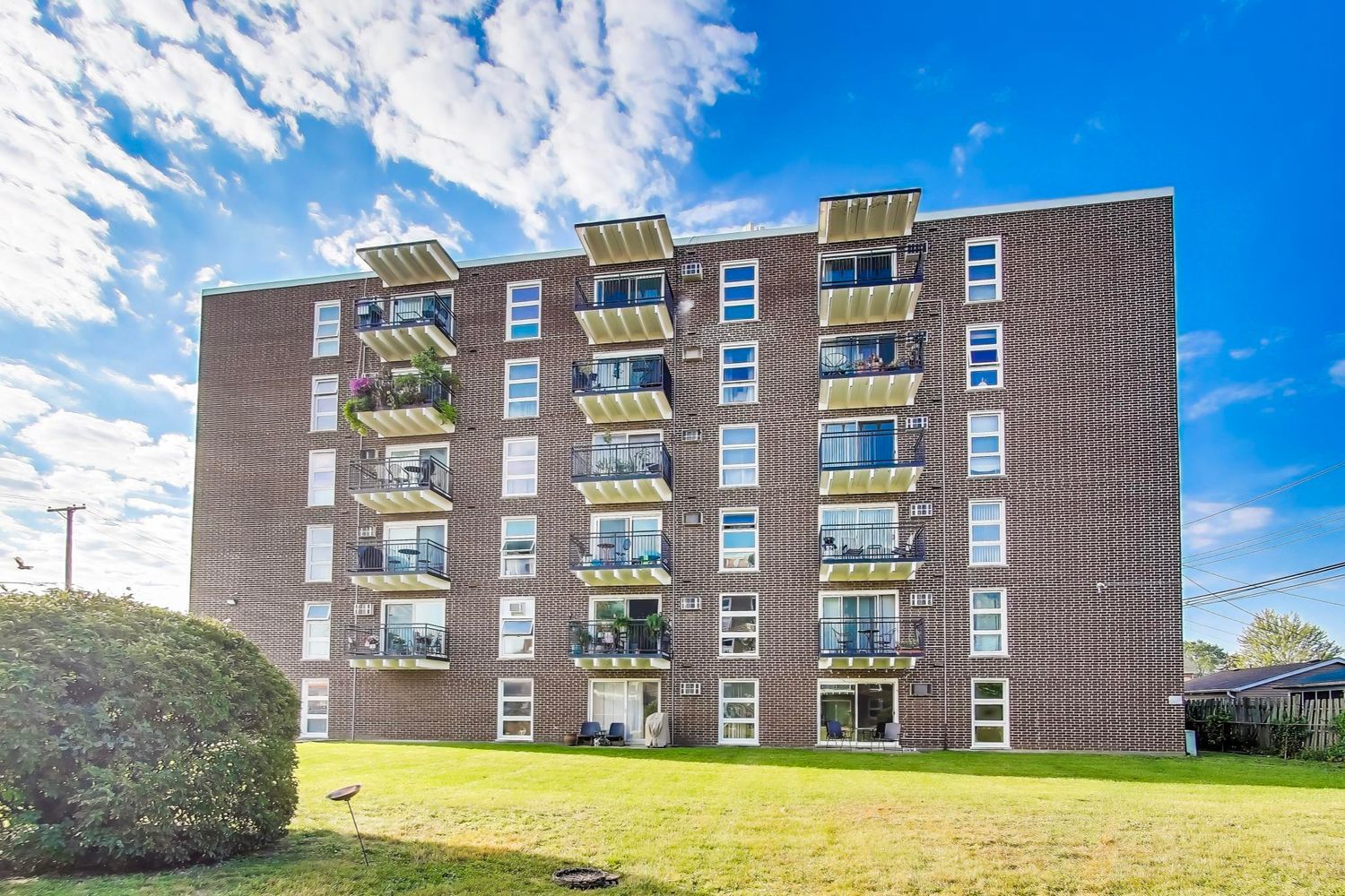 a front view of a building with a garden
