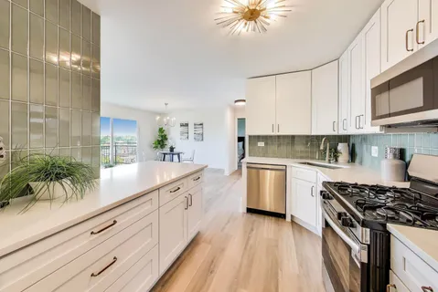 a kitchen with a white cabinets and appliances