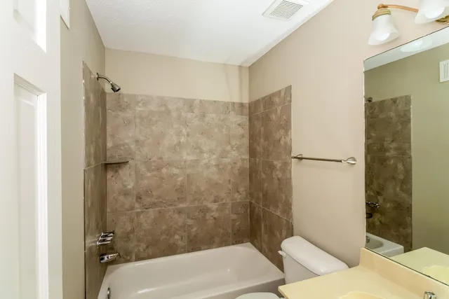 a bathroom with a bathtub and shower