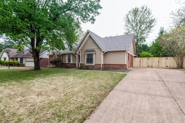 a front view of house with yard and green space