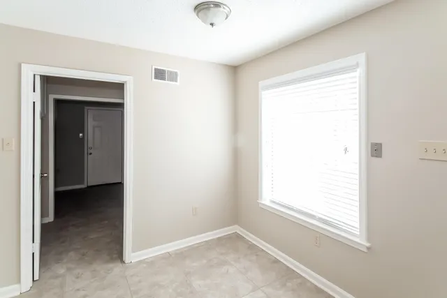 a view of an empty room with a window