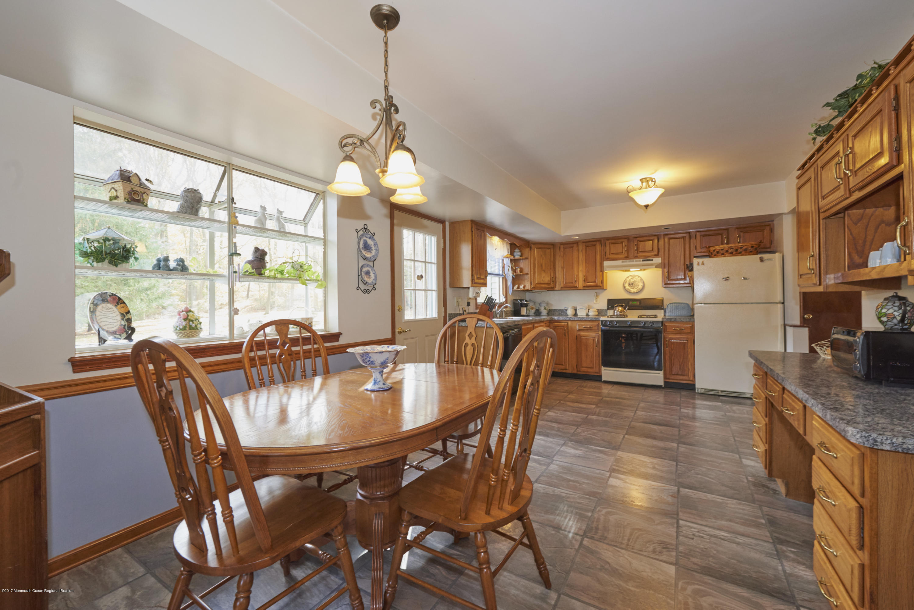 339 Florence Road Middletown, NJ 07748 - Photo 8 of 20 a dining room with furniture a chandelier and wooden floor