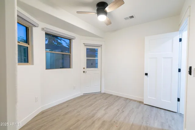 a view of an empty room with wooden floor