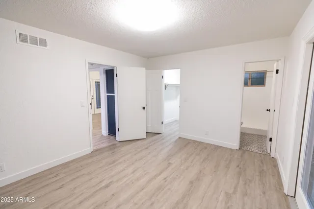 an empty room with wooden floor