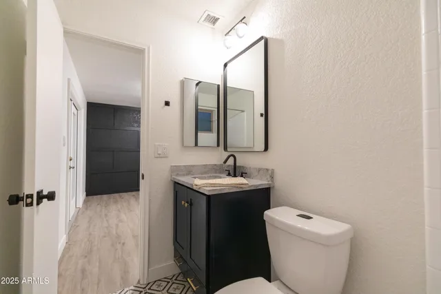 a bathroom with a toilet sink and mirror