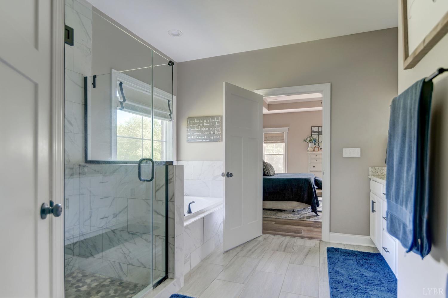 2667 Bellevue Road Forest, VA 24551 - Photo 13 of 55 a bathroom with a tub shower and mirror