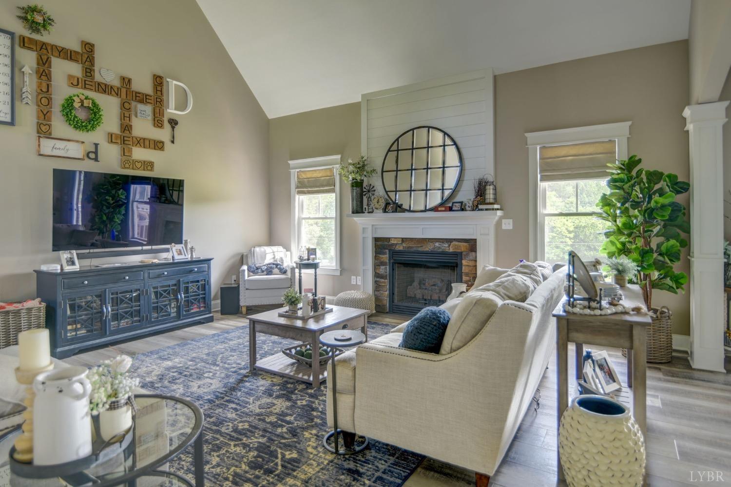 2667 Bellevue Road Forest, VA 24551 - Photo 17 of 55 a living room with furniture a fireplace and a flat screen tv
