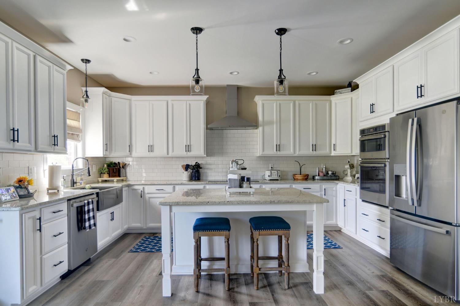 2667 Bellevue Road Forest, VA 24551 - Photo 18 of 55 a kitchen with stainless steel appliances granite countertop a white cabinets and wooden floor