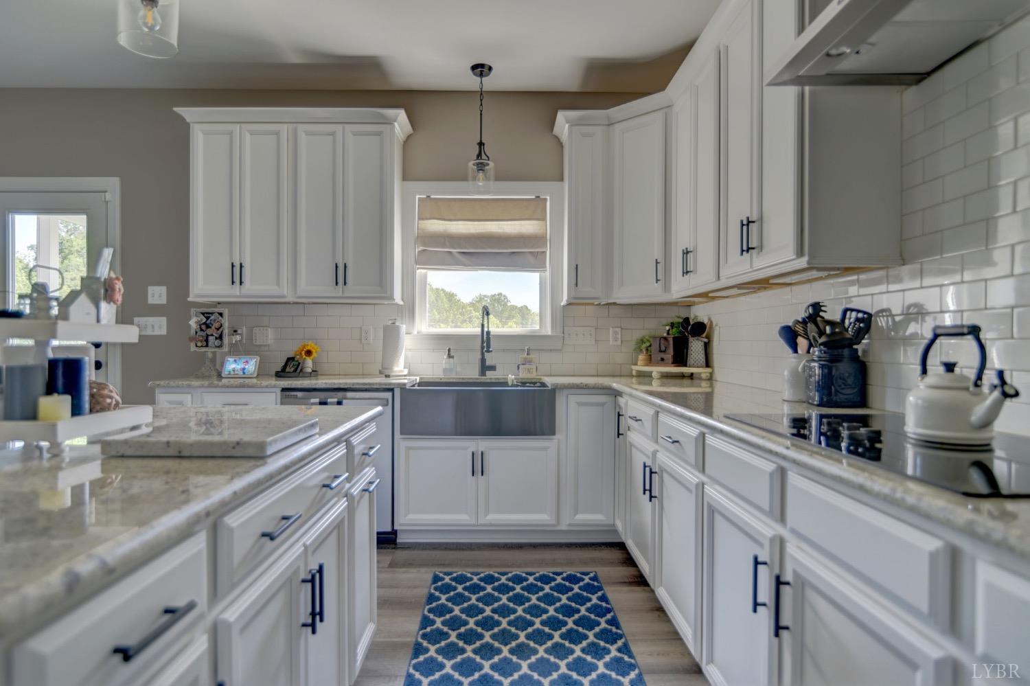 2667 Bellevue Road Forest, VA 24551 - Photo 20 of 55 a kitchen with granite countertop a sink stainless steel appliances and cabinets