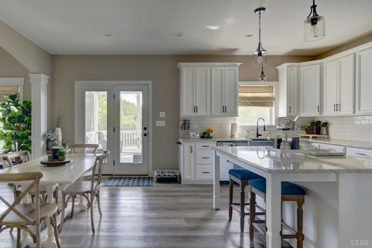 2667 Bellevue Road Forest, VA 24551 - Photo 27 of 55 a kitchen with stainless steel appliances granite countertop a stove a refrigerator a sink a dining table and chairs with wooden floor