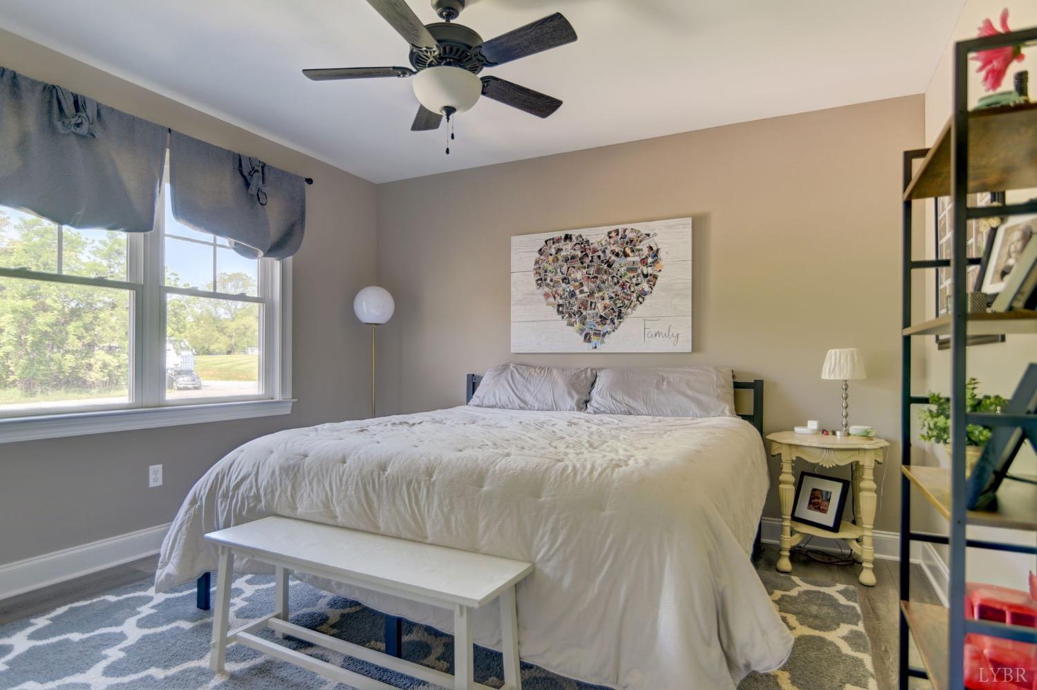 2667 Bellevue Road Forest, VA 24551 - Photo 35 of 55 a bedroom with a bed and a chandelier