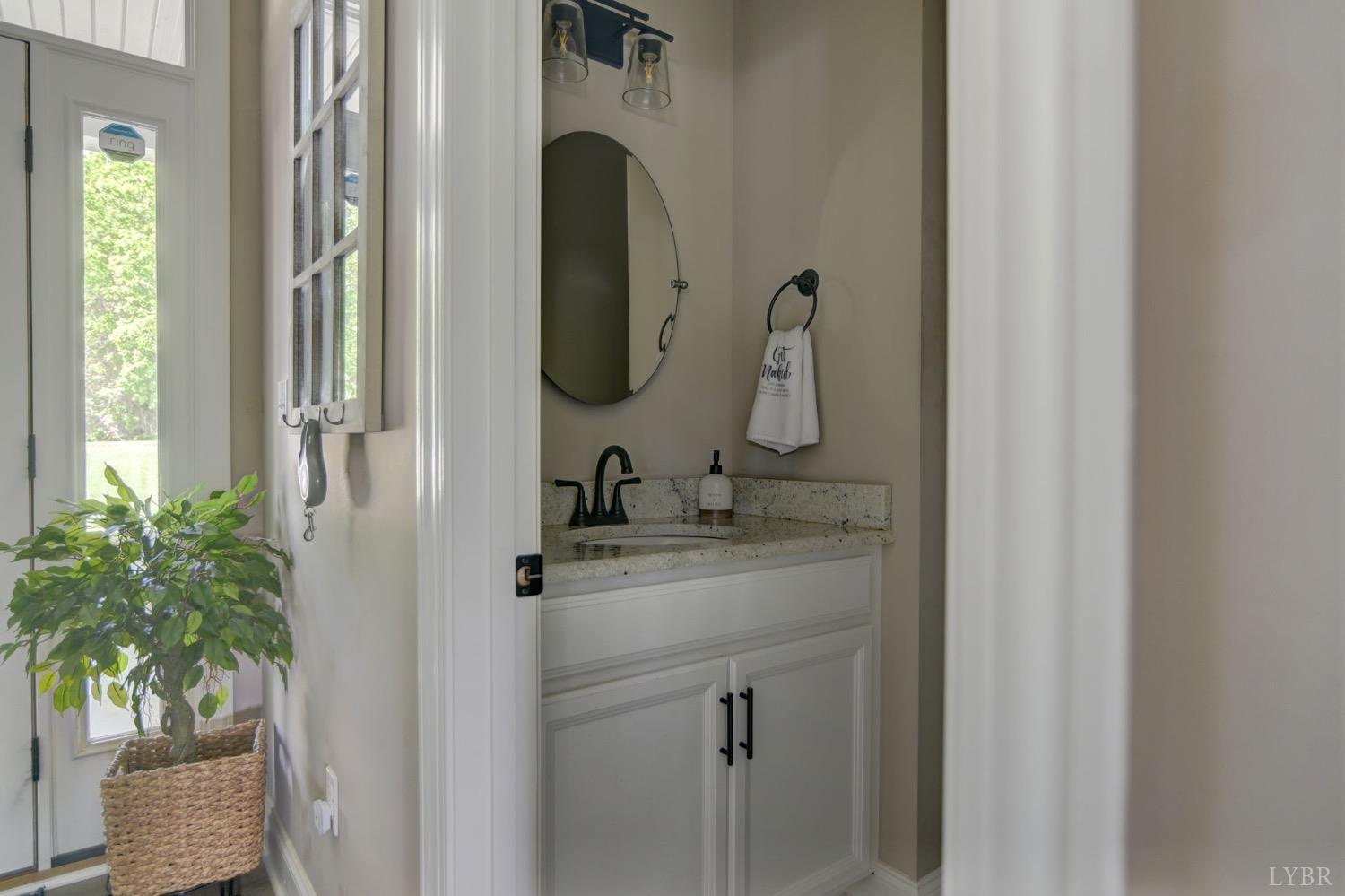 2667 Bellevue Road Forest, VA 24551 - Photo 6 of 55 a bathroom with a granite countertop sink a mirror and vanity