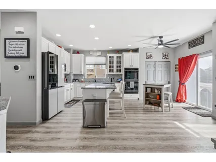 a open kitchen with stainless steel appliances kitchen island granite countertop a refrigerator and stove