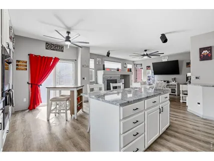 a kitchen with stainless steel appliances kitchen island granite countertop a stove and a sink