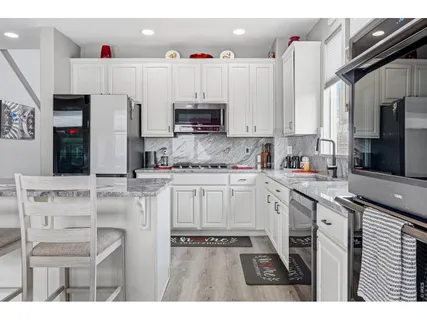 a kitchen with cabinets and white appliances