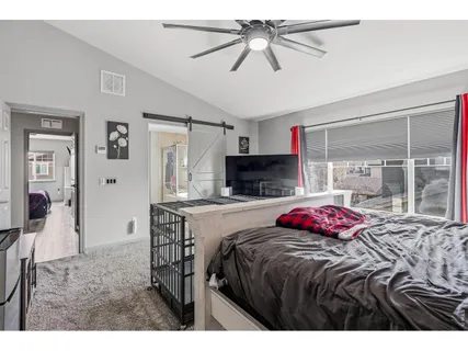 a bedroom with a bed a window and a fireplace