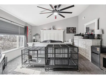 a bedroom that has a bed and a table in it