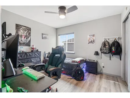 a living room with furniture gym equipment and a flat screen tv
