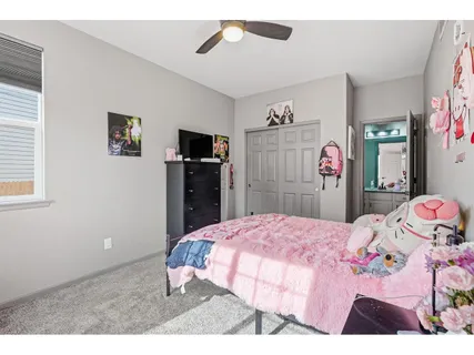 a bedroom with a bed and a television