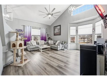 a living room with furniture and a floor to ceiling window