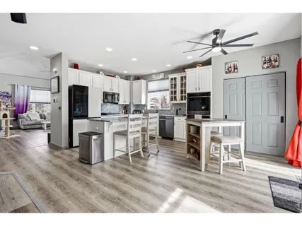 a view of kitchen with sink microwave and refrigerator