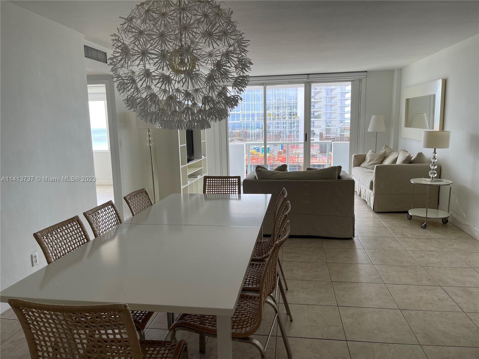 Surfside Surfside, FL 33154 - Photo 18 of 27 a view of a dining room and livingroom with furniture wooden floor a chandelier