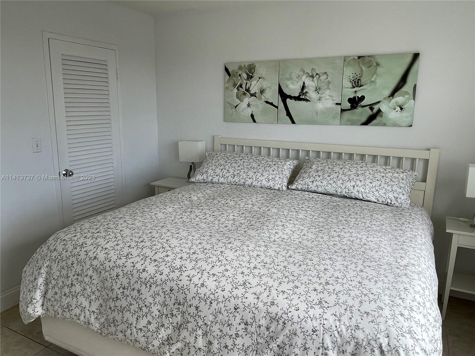 Surfside Surfside, FL 33154 - Photo 26 of 27 a bedroom with a bed and painting on the wall