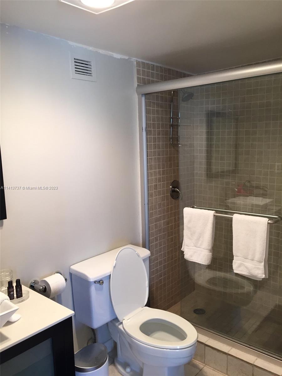 Surfside Surfside, FL 33154 - Photo 7 of 27 a bathroom with a toilet a sink and mirror