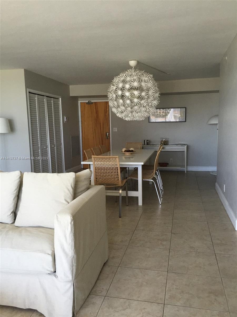 Surfside Surfside, FL 33154 - Photo 8 of 27 a living room with furniture a chandelier and a large window