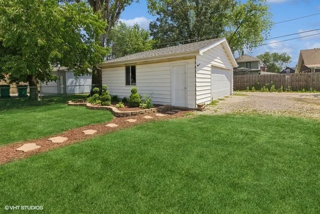 a view of backyard of house with green space