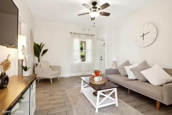 a living room with furniture and wooden floor