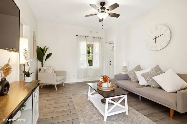 a living room with furniture and wooden floor