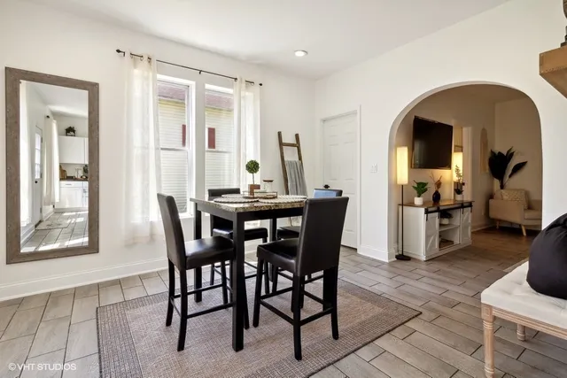 a view of a dining room with furniture and a window