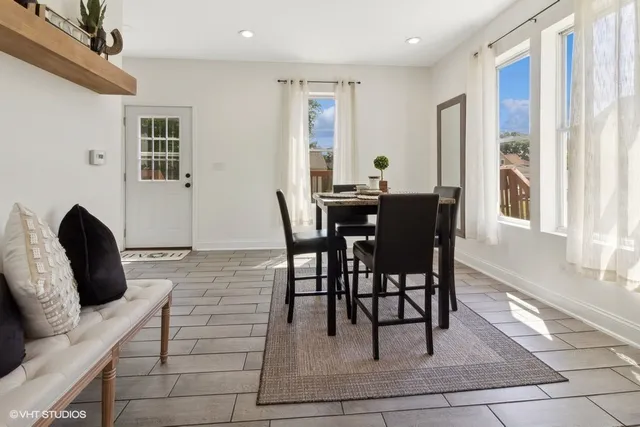 a view of a dining room with furniture and wooden floor