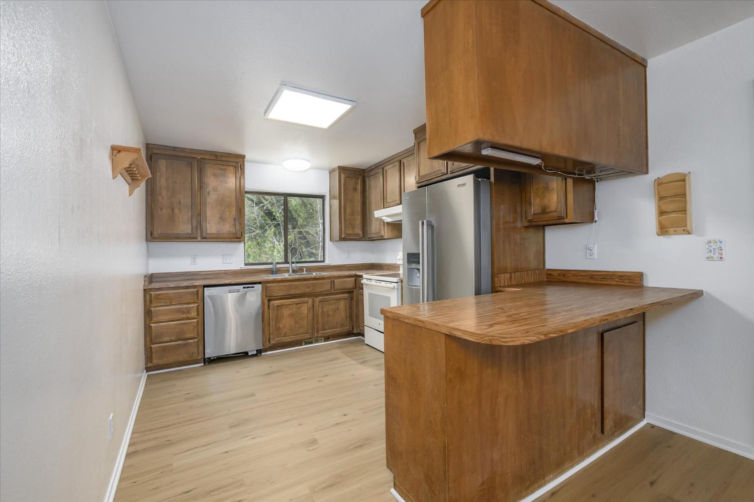 4910 Chisholm Trail Placerville, CA 95667 - Photo 11 of 41 a kitchen with stainless steel appliances a sink and a refrigerator