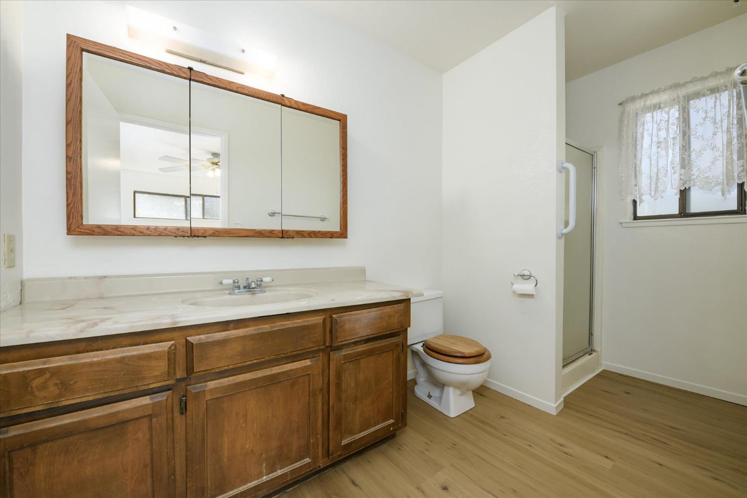 4910 Chisholm Trail Placerville, CA 95667 - Photo 15 of 41 a bathroom with a toilet sink and mirror