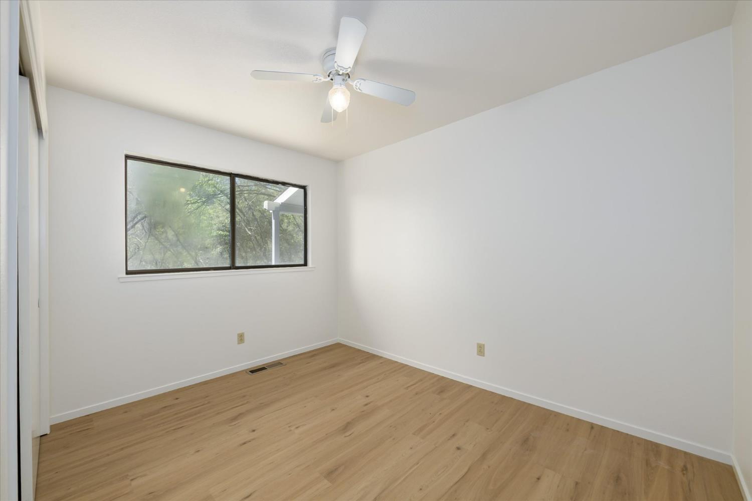 4910 Chisholm Trail Placerville, CA 95667 - Photo 16 of 41 wooden floor in an empty room with a window