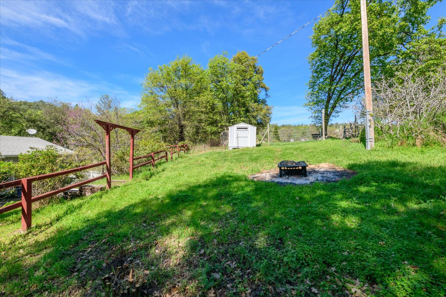 4910 Chisholm Trail Placerville, CA 95667 - Photo 24 of 41 a green field with lots of trees in the background