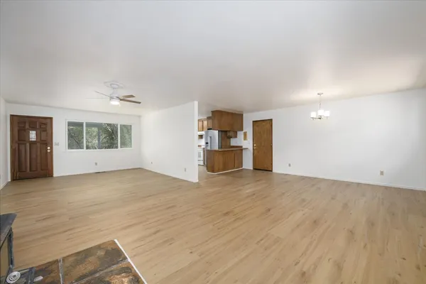 an empty room with a kitchen and window