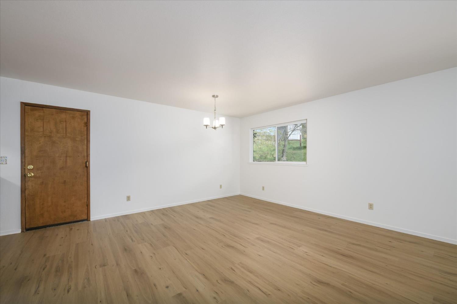 4910 Chisholm Trail Placerville, CA 95667 - Photo 9 of 41 an empty room with wooden floor and windows