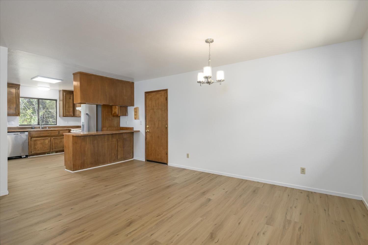 4910 Chisholm Trail Placerville, CA 95667 - Photo 10 of 41 a view of kitchen and empty room with wooden floor