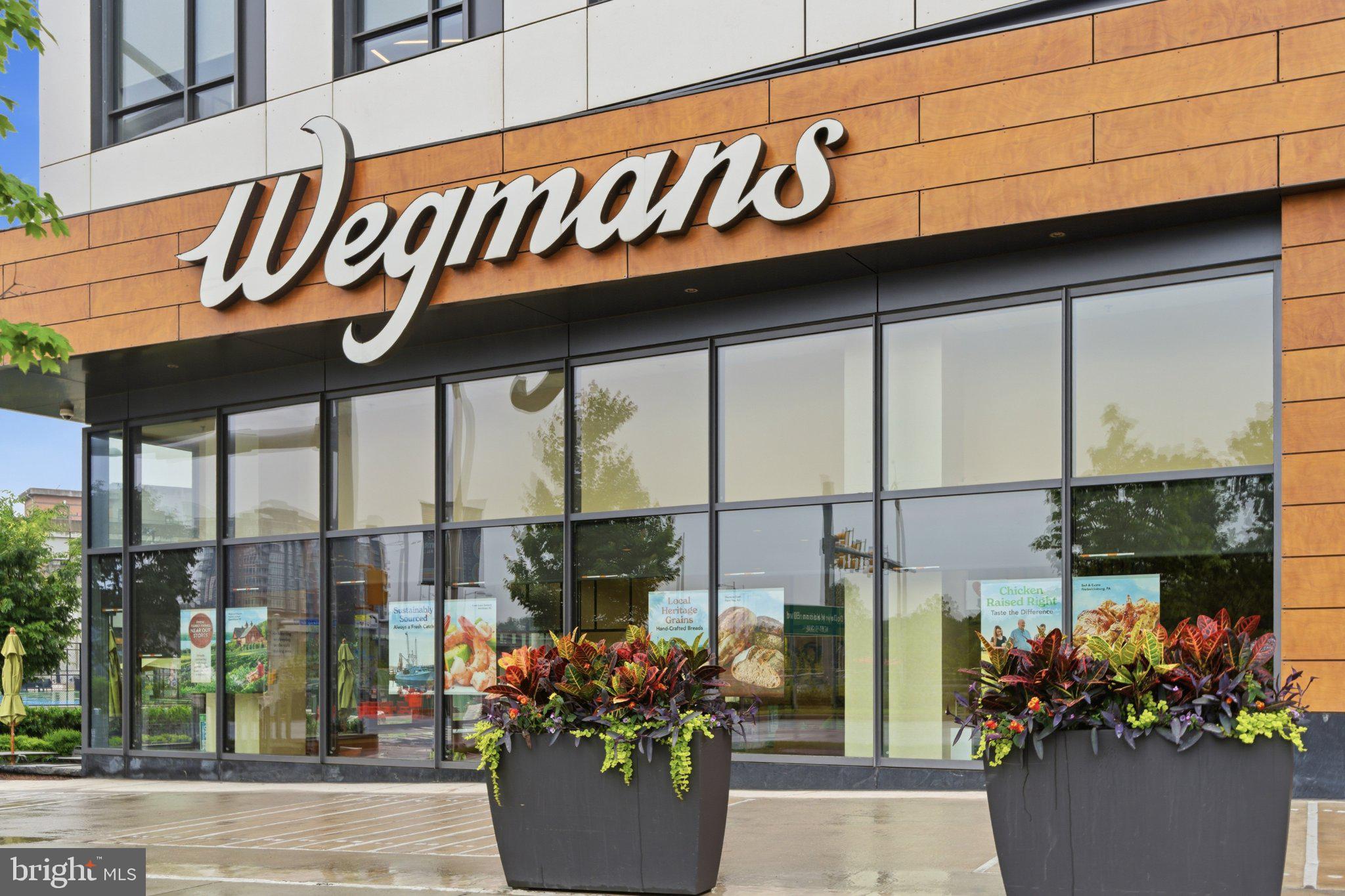 1580 Spring Gate Dr., Unit 4303 McLean, VA 22102 - Photo 39 of 41 Wegmans storefront with vibrant planters.