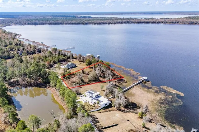 an aerial view of a house with a lake view