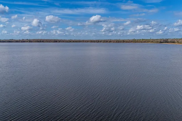 an aerial view of a house with a lake view