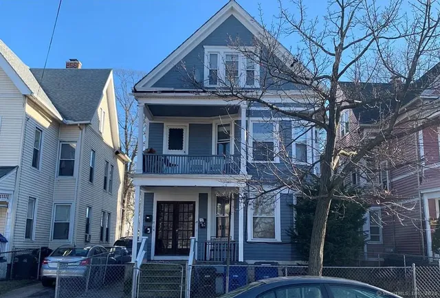 a front view of a residential apartment building with a yard