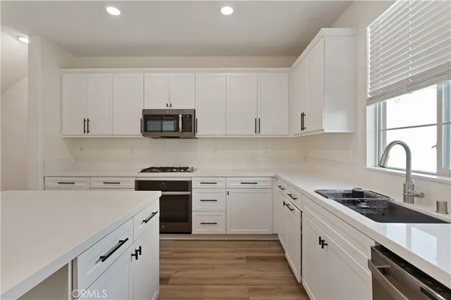 a stove top oven sitting inside of a kitchen