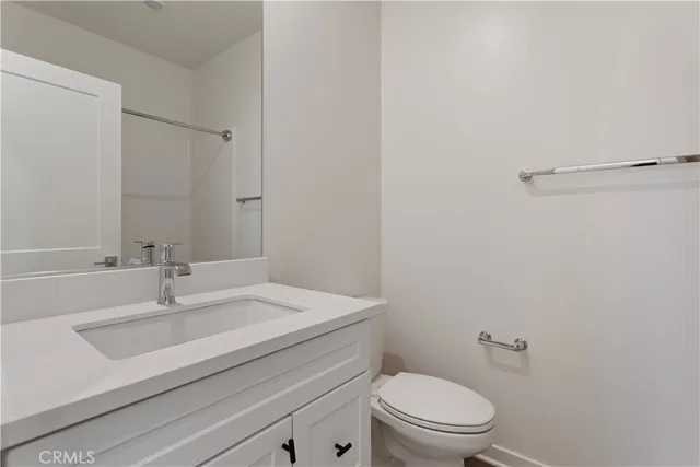 a kitchen with a stove a sink a kitchen island with wooden cabinets and stainless steel appliances