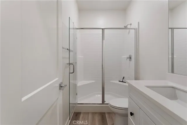 a kitchen with a sink a window a refrigerator and white cabinets