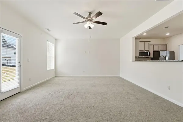 an empty room with closet and ceiling fan