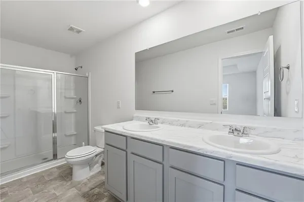 a bathroom with a sink toilet a mirror and shower
